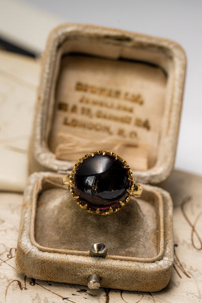 Unisex solid gold ring set with a garnet cabochon. A stunning revival of the 19th century jewelry designs and heavily inspired by oriental influence.  This ring is skuilfully hand-crafted by our goldsmith from recycled gold and ethically sourced garnet.
